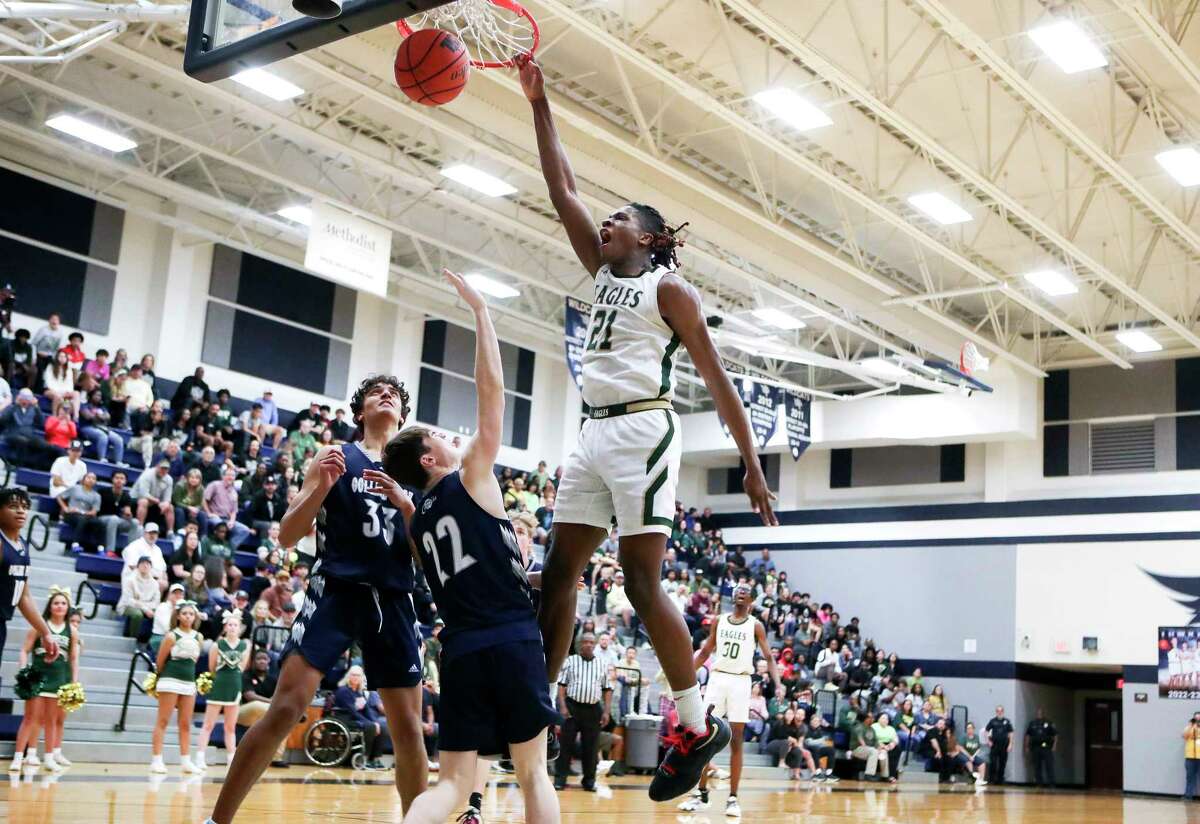Cypress Falls' Joseph Tugler (21) reacts as he dunks the ball in front of College Park's Ryan Beach (22) during the third quarter of a Region II-6A area high school playoff game at Tomball Memorial High School, Friday, Feb. 24, 2023, in Tomball.