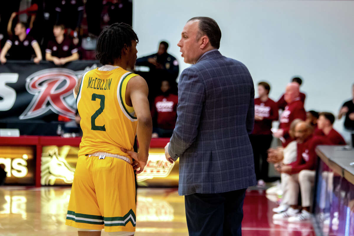 Javian McCollum talks things over with Siena coach Carmen Maciariello during the game against Rider on Friday, Feb. 24, 2023.