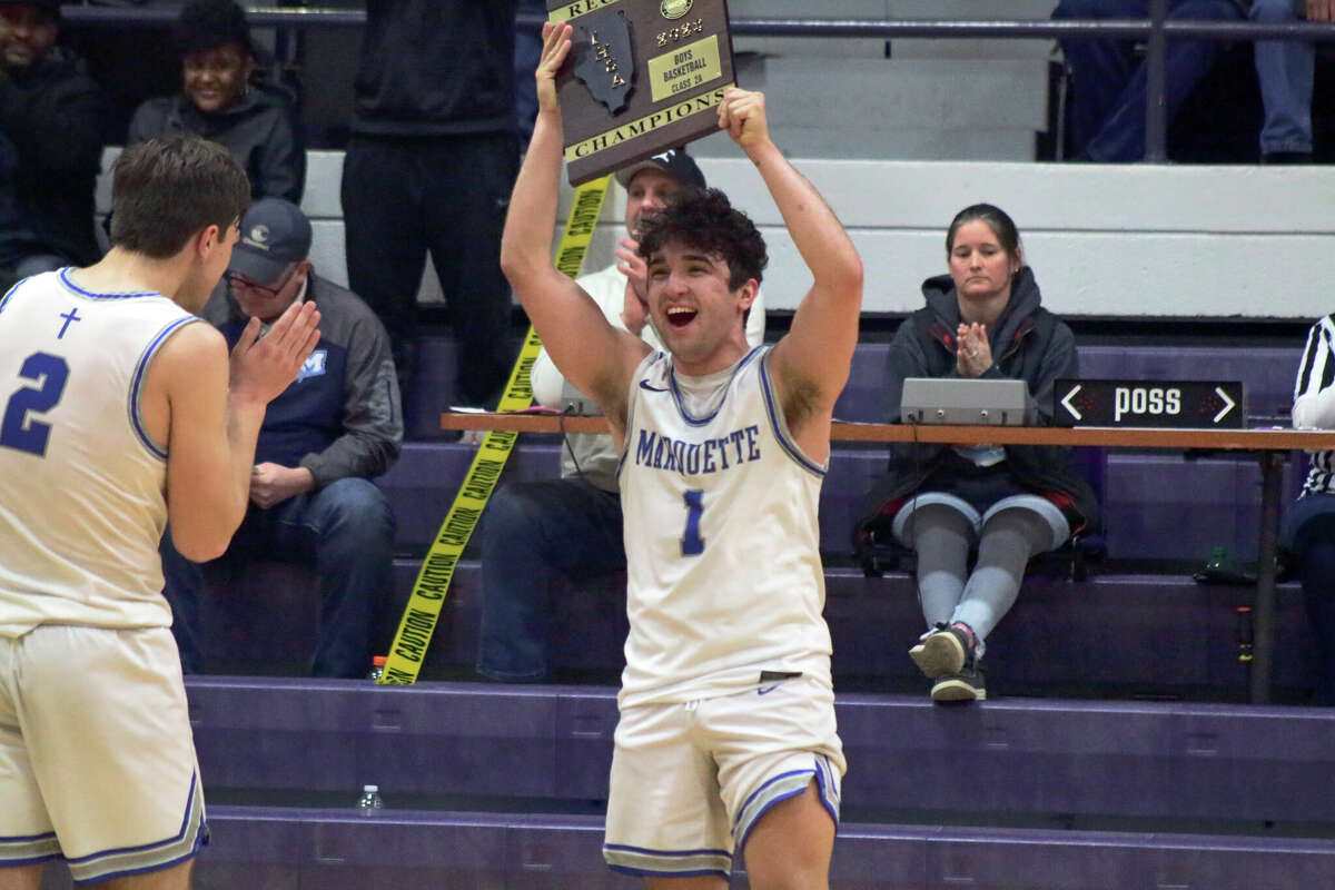 Parker Macias hoists the regional title plaque after the Explorers' 43-32 win over Pana in the Class 2A Litchfield Regional championship game on Friday.