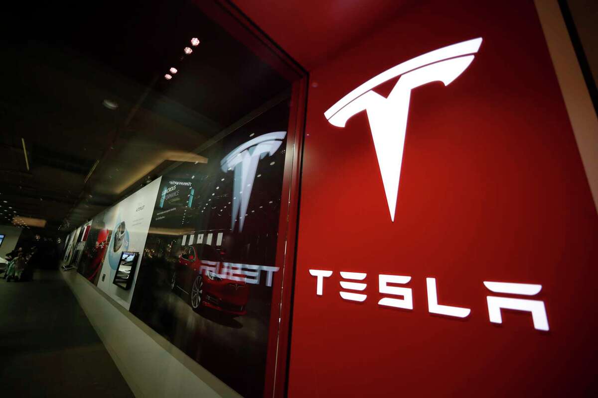FILE - A sign bearing the Tesla company logo is displayed outside a Tesla store in Cherry Creek Mall in Denver, Colorado, Feb. 9, 2019. Mexico is undergoing competition among several states in 2023 to attract a possible Tesla facility.
