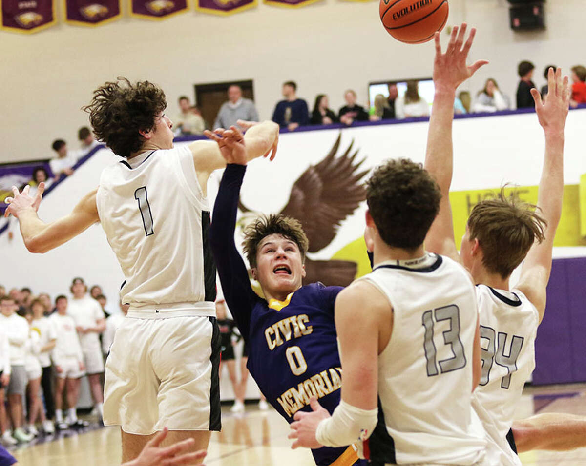 CM's Adam Ogden (0) tries to get off a shot in the lane defended by Triad's Drew Winslow (1), McGrady Noyes (13) and Tyler Thompson on Wednesday in the semifinals of the CM Class 3A Regional in Bethalto.