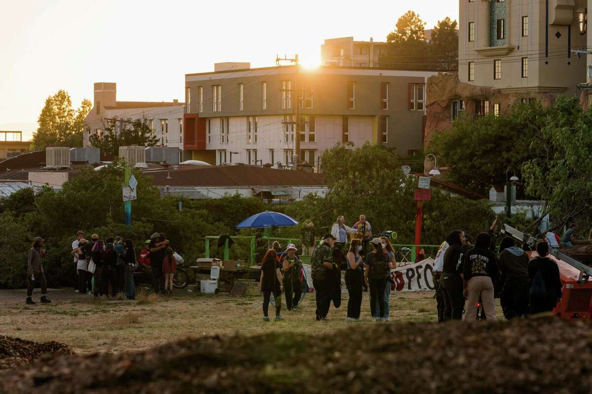 Community members gather in small groups as people organize for further resistance at People’s Park in Berkeley on Aug. 3, 2022. Earlier in the day protestors rallied in a confrontation with police to stop work on preparing the park to be turned into student housing.