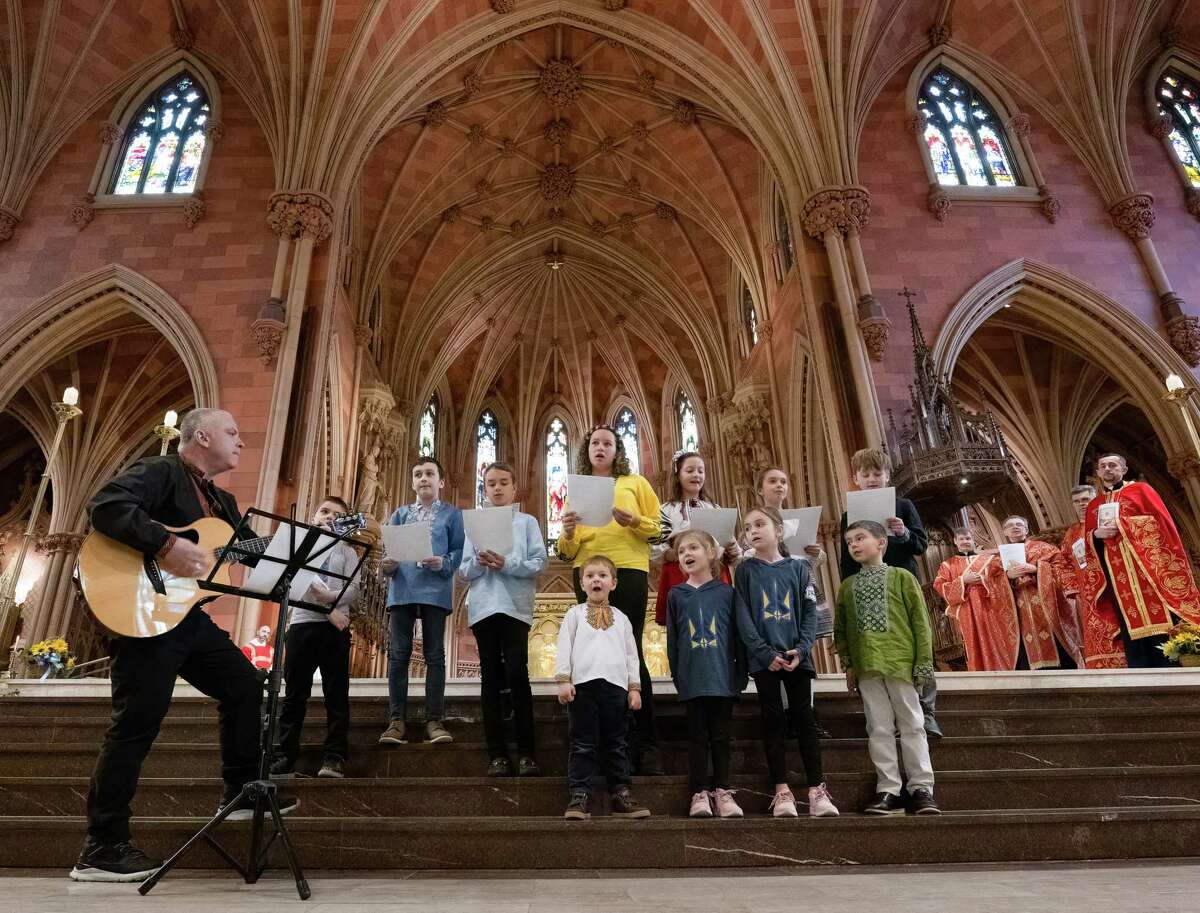 The Capital District School of Ukrainian Studies Choir sings performs during an ecumenical service to mark the one-year anniversary of the Russian invasion of Ukraine at the Cathedral of the Immaculate Conception on Saturday, Feb. 25, 2023, in Albany, NY.