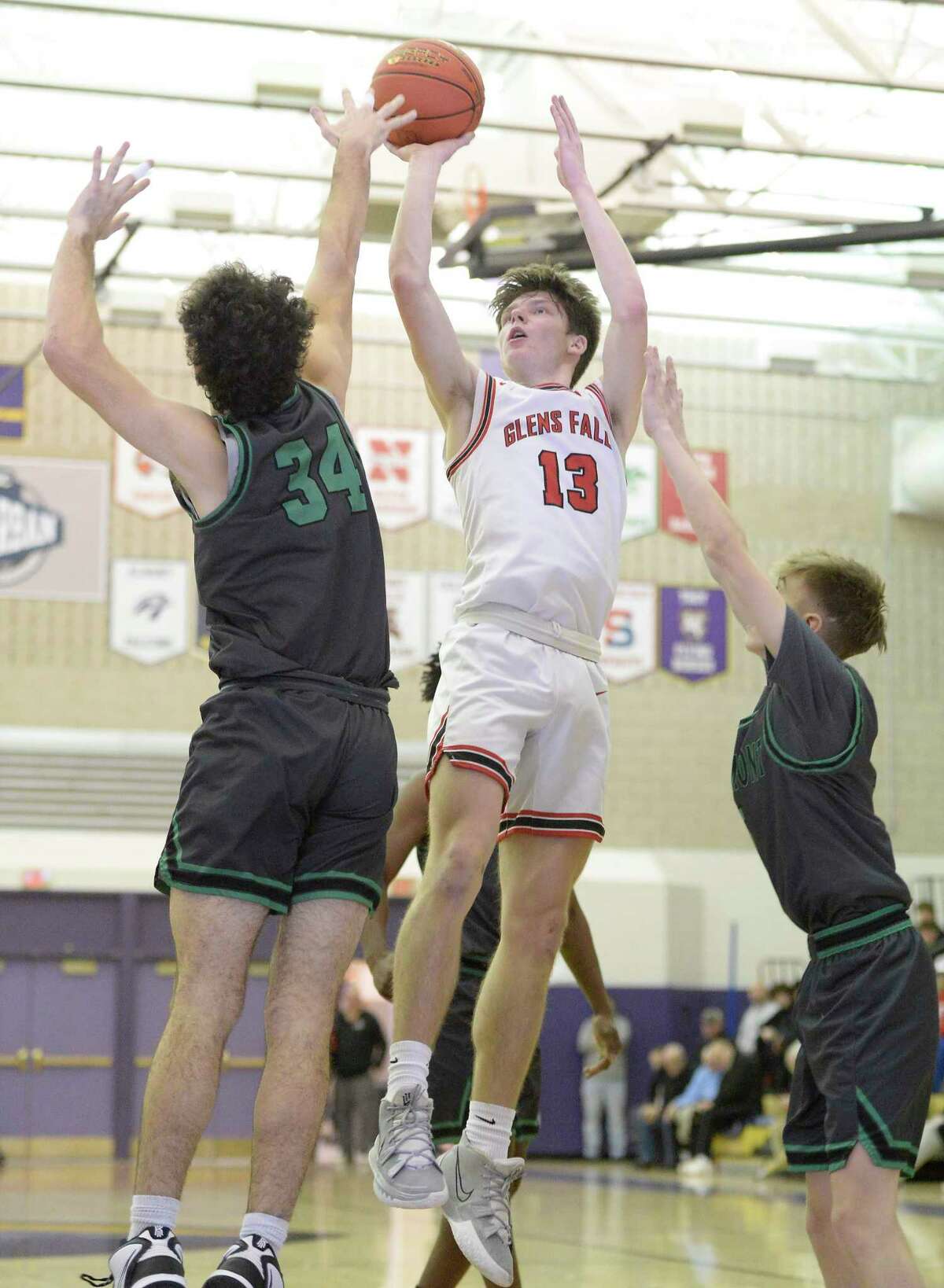 Glens Falls' Kellen Driscoll shoots the ball over the arms of Schalmont's Andrew Schraa during their Class B semifinal game at Ballston Spa High School on Saturday, Feb. 25, 2023, in Ballston Spa, N.Y. (Jenn March, Special to the Times Union)