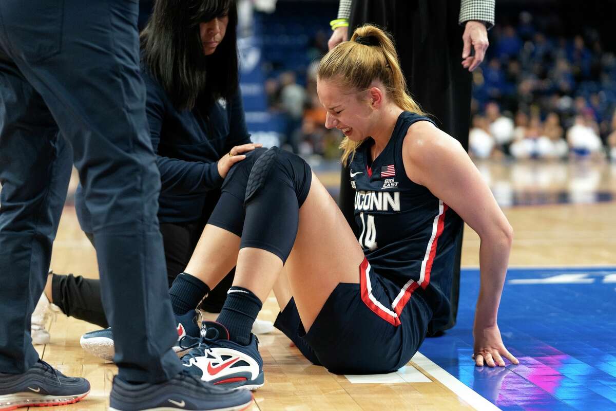UConn forward Dorka Juhasz is helped off the court after an injury during the first half of an NCAA college basketball game against DePaul, Saturday, Feb. 25, 2023, in Chicago. (AP Photo/Erin Hooley)