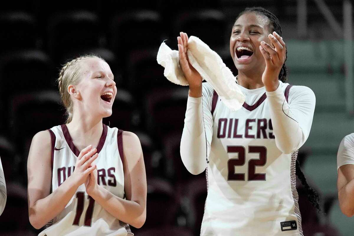Pearland guard RyLee Grays (22) celebrates the team's win over Summer Creek with Emily Anderson in the Region III-6A final high school basketball playoff game, Saturday, Feb. 25, 2023, in Houston.