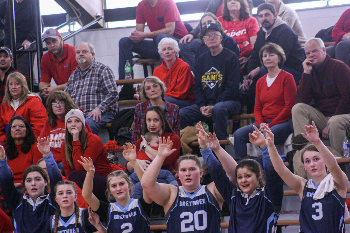 The Brethren bench and Manistee Catholic Central fans await a free throw on Feb. 25, 2023 at Manistee Catholic Central High School. 