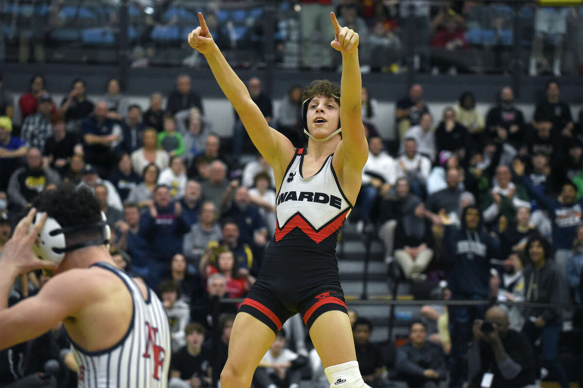 Fairfield Warde's Dominick Spadaro points to the crowd after scoring four points in the closing seconds to defeat New Fairfield's Vincent Tripaldi in the 126-pound final at the CIAC State Open wrestling championships in New Haven on Saturday, Feb. 25, 2023.