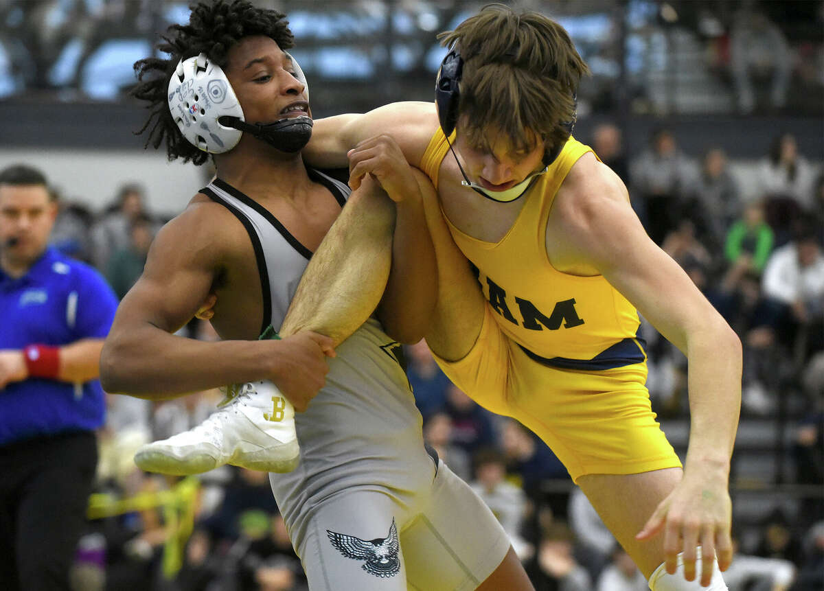 Xavier's Raekwon Shabazz attemots to take down RHAM's Ben Fournier during the 106-pound final at the CIAC State Open wrestling championships in New Haven on Saturday, Feb. 25, 2023.