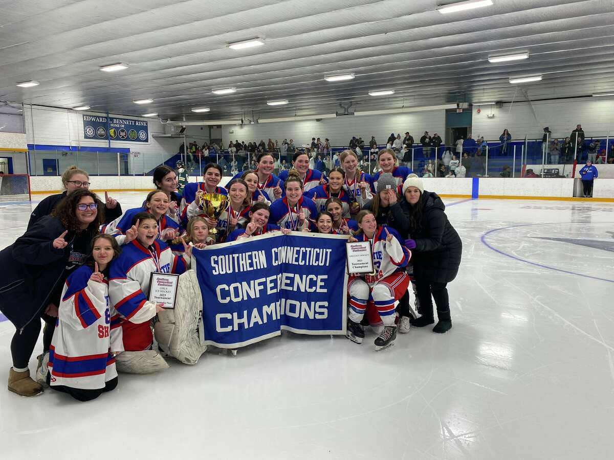 Members of the West Haven / Sacred Heart Academy girls hockey team celebrate after defeating Hamden 1-0 in double overtime to win the SCC tournament title Saturday at Bennett Rink.