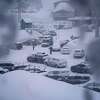 People through the parking area of the Alpine Base Area at Palisades Tahoe during a winter storm Friday, Feb. 24, 2023, in Alpine Meadows, Calif. California and other parts of the West are facing heavy snow and rain from the latest winter storm to pound the United States.