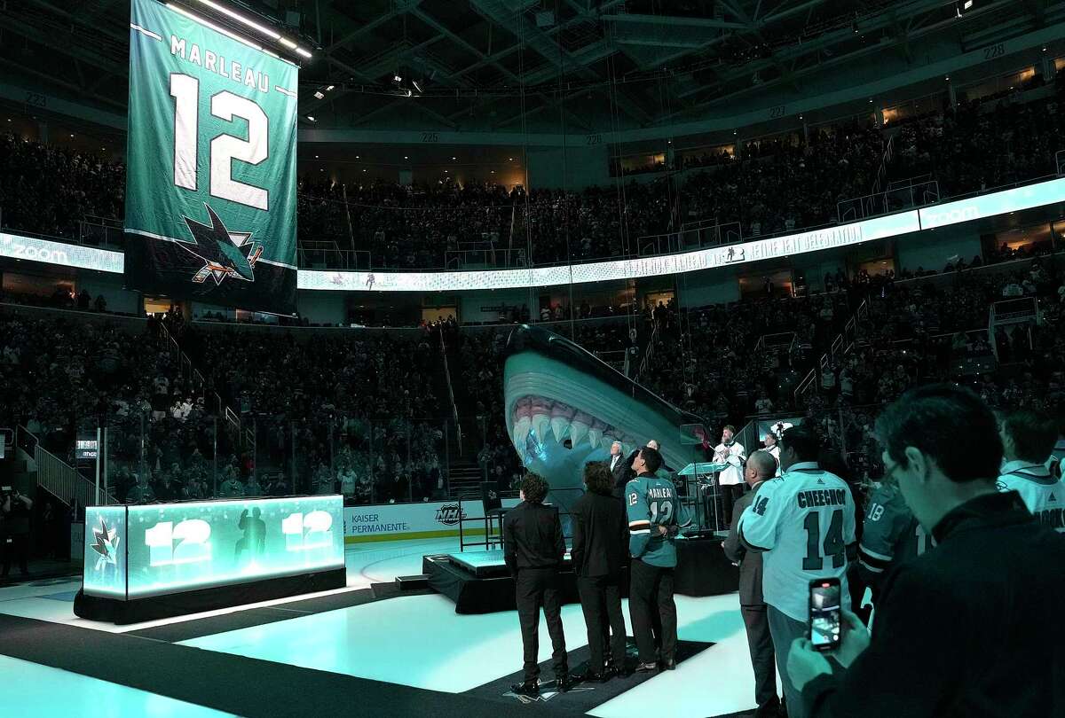 Former San Jose Shark Patrick Marleau stands with his wife and children as they watch the Sharks raise his No. 12 jersey to the rafters during a pregame ceremony prior to the start of their game against the Chicago Blackhawks on Saturday in San Jose.