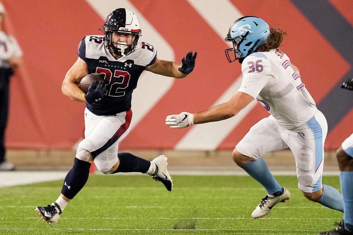 Houston Roughnecks running back Max Borghi (22) runs the ball outside chased down by Arlington Renegades linebacker Colin Schooler (36) during the first half an XFL football game Sunday, Feb. 26, 2023, in Houston.