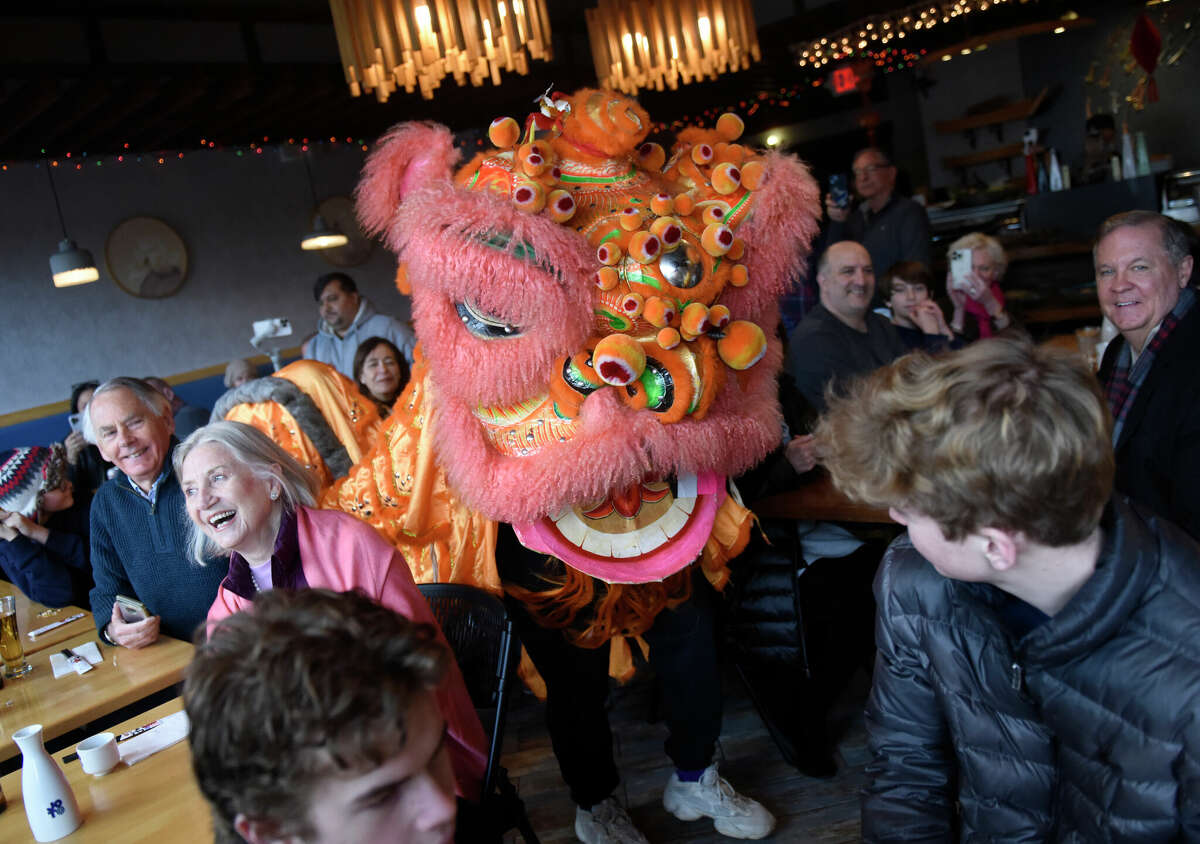 Dancers perform the dragon dance at Sushi Soba in Old Greenwich, Conn. Sunday, Feb. 26, 2023. After a two year hiatus, the dragon dance returned to Sushi Soba on Sunday to bring good luck for Chinese New Year. The restaurant celebrated its eight year anniversary and the opening of a new restaurant on Greenwich Avenue, Poke Boba.