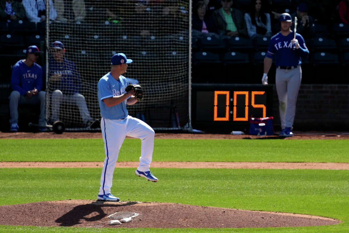 Kansas City Royals Nick Wittgren throws before a pitch clock runs down during the fifth inning of a spring training baseball game against the Texas Rangers Friday, Feb. 24, 2024, in Surprise, Ariz. (AP Photo/Charlie Riedel)