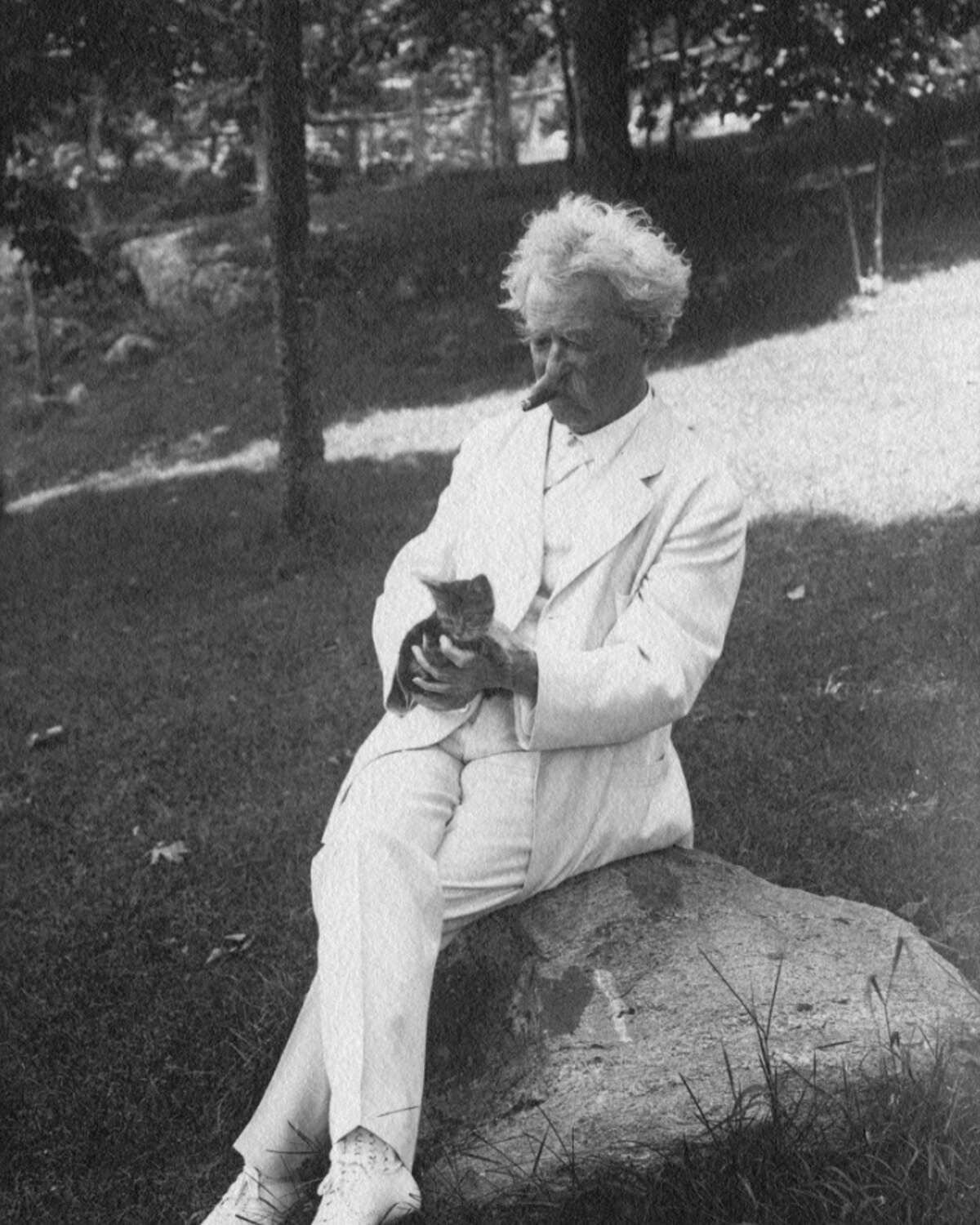 Samuel Clemens and his cat enjoy some time in Tuxedo, N.Y., in 1907. The author’s iconic white suit jacket will be featured in the exhibit, a loan from the Mark Twain Boyhood Museum in Hannibal, M.O.