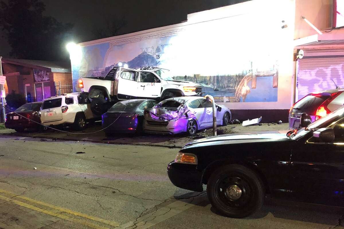 A white pickup truck landed on several parked cars in Houston's Third Ward after being chased by police on Friday.