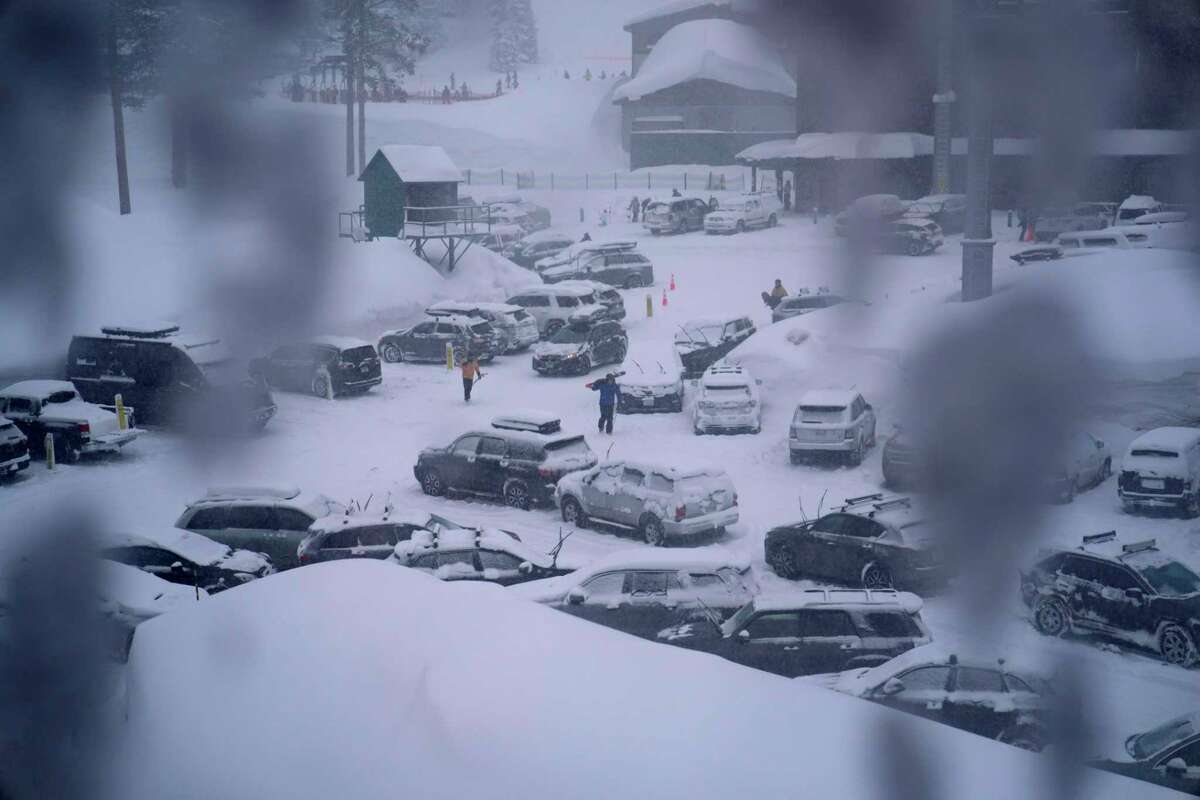 Snow filled a parking lot at Palisades Tahoe during a storm Friday. California and other parts of the West are facing heavy snow and rain from the latest winter storm.