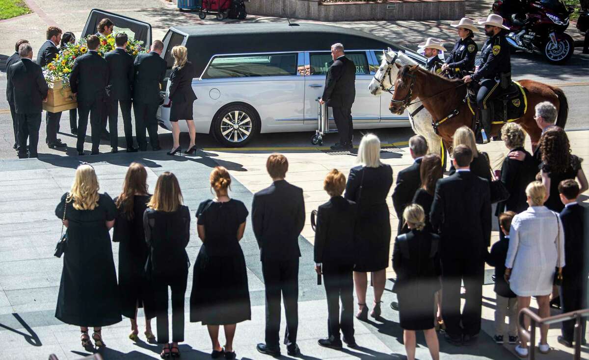 BJ “Red” McCombs’ casket is placed in a hearse Monday, Feb. 27, 2023, by his grandsons after the memorial service for the San Antonio business titan at the Tobin Center in downtown San Antonio. McCombs died Feb. 19 at age 95. Raised in the West Texas town of Spur, he built an empire that included holdings in auto dealerships, communications, professional sports teams, oil and gas exploration, real estate and ranching.