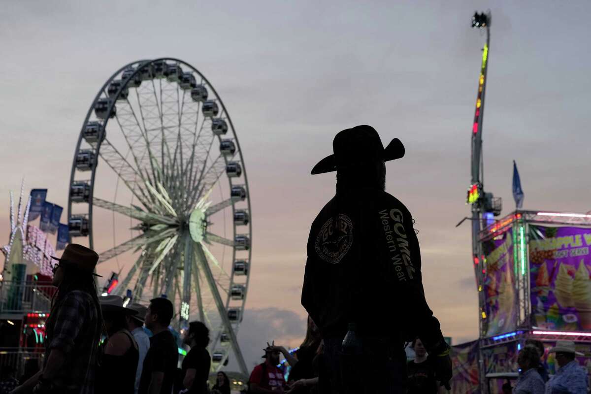 The Houston Livestock Show & Rodeo World's Championship Bar-B-Que Contest audience walk around the fair gorunds