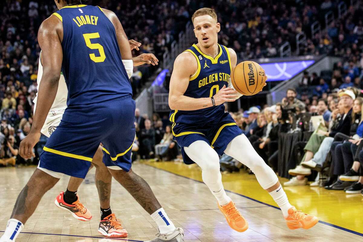 Golden State Warriors guard Donte DiVincenzo (0) drives the ball during the second quarter of his NBA basketball game against the Minnesota Timberwolves in San Francisco, Calif. Sunday, Feb. 26, 2023.
