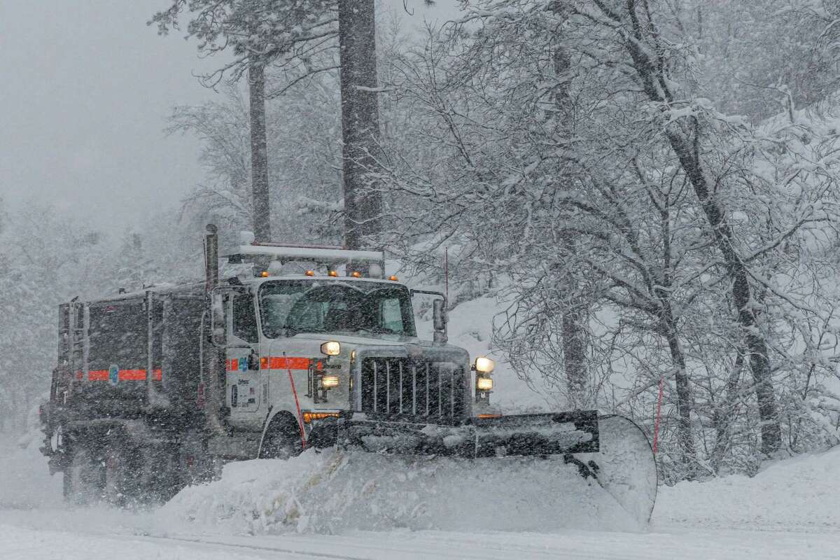 A Caltrans snowplow works along Highway 120 near the South Fork of the Tuolumne River before conditions deteriorated into a whiteout.