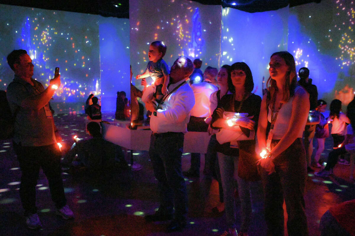 Those who check out "Disney Animation: Immersive Experience" are given bracelets that light up with different colors in coordination with the images projected all around them.