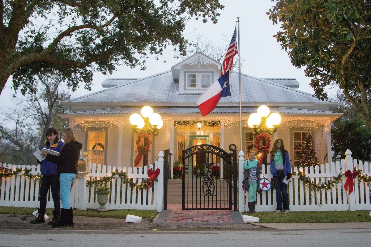 People walk house to house during the annual Montgomery Candlelight Home Tour. Montgomery officials are considering granting tax exemptions to homeowners of historical structures if they meet certain criteria. 