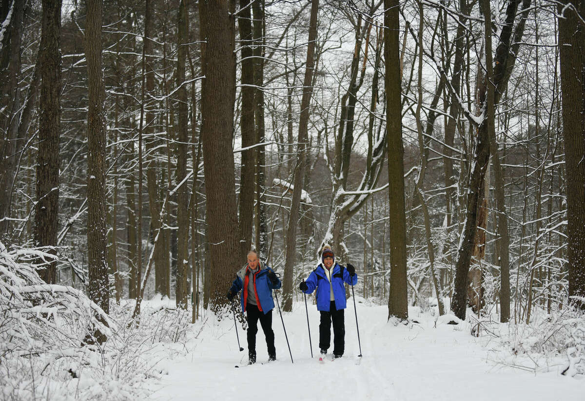 Jack and Deborah Gault, of Darien, ski through Waveny Park in New Canaan, Conn. Tuesday, Feb. 28, 2023. The area received its first measurable snow accumulation of the year, albeit just a few inches, from a storm Monday night through Tuesday morning.