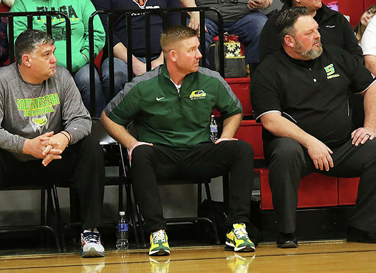 Southwestern coach Jason Darr, middle, and assistants Shaun Watson, left, and Pat Keith watch during a game this season. Southwestern will host its own Christmas tournament next december.