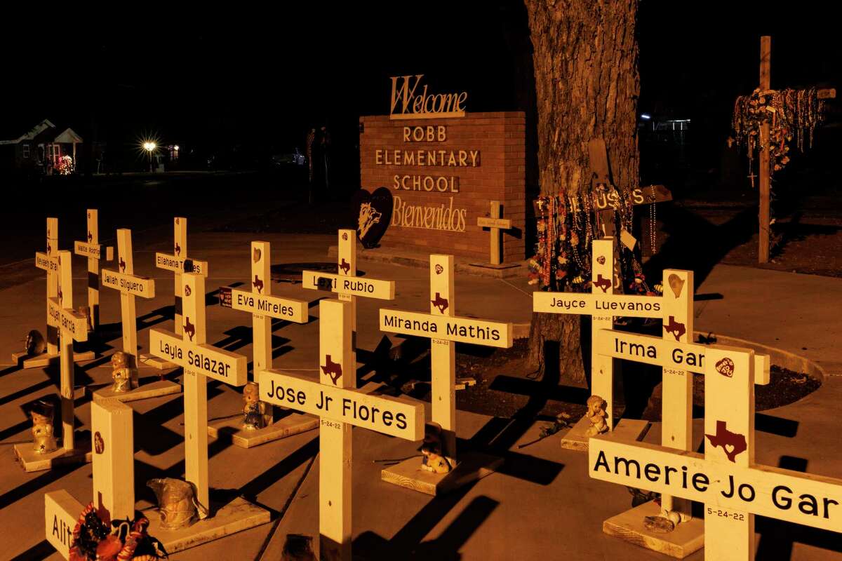 Wooden crosses outside Robb Elementary School in January. The toll of violence can be felt across Uvalde, Texas and the nation.
