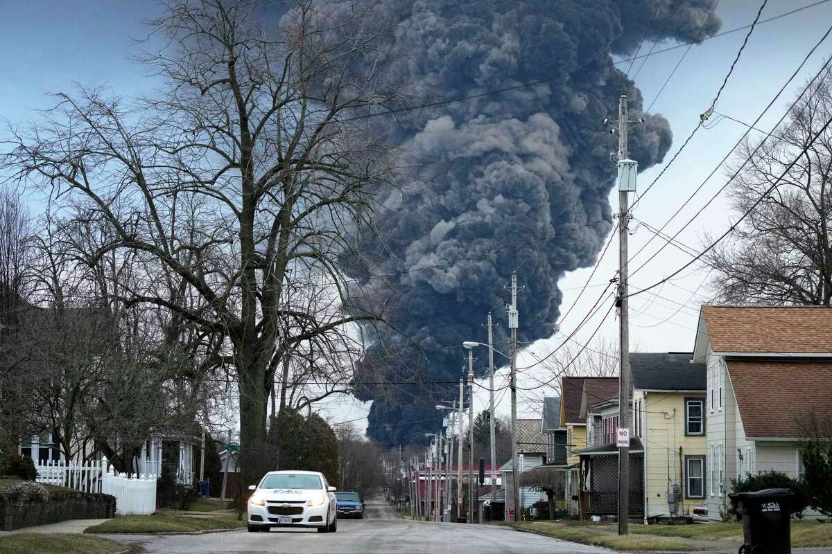 A black plume rises over East Palestine, Ohio, after a controlled detonation of a portion of the derailed Norfolk Southern trains, Feb. 6, 2023. On Tuesday, Feb. 28, in the wake of a fiery Ohio derailment and other recent crashes, federal regulators urged that freight railroads should reexamine the way they use and maintain the detectors along the tracks that are supposed to spot overheating bearings.