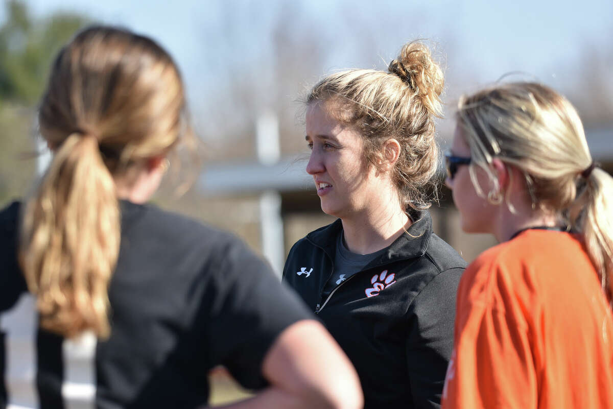 Edwardsville coach Caty Happe talks to a handful of players during practice Tuesday inside the District 7 Sports Complex.