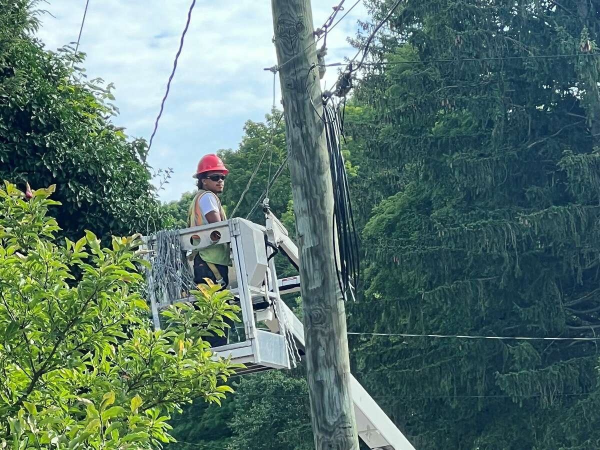 A line worker installs fiber optic cable to a utility pole in Cheshire during the summer of 2022. A new study released this week by the Connecticut Conference of Municipalities found that state residents want broadband service that is more affordable and reliable.