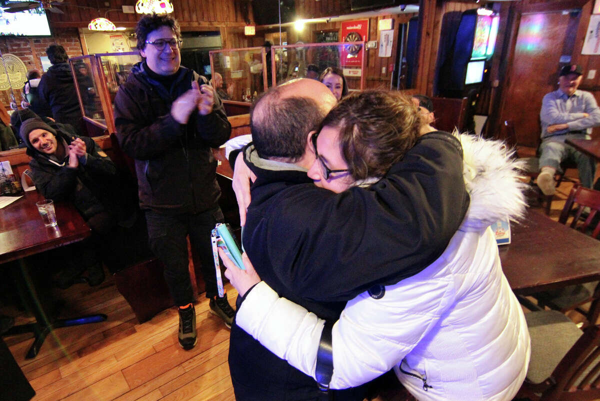 Democratic candidate Anabel Figueroa receives a hug from her husband Robert at Murphy's Townhouse CafÃ© in Stamford, Conn., on Tuesday February 28, 2023. Figueroa defeated Republican candidate Olga Anastos for the 148th District seat in the state House in a special election.
