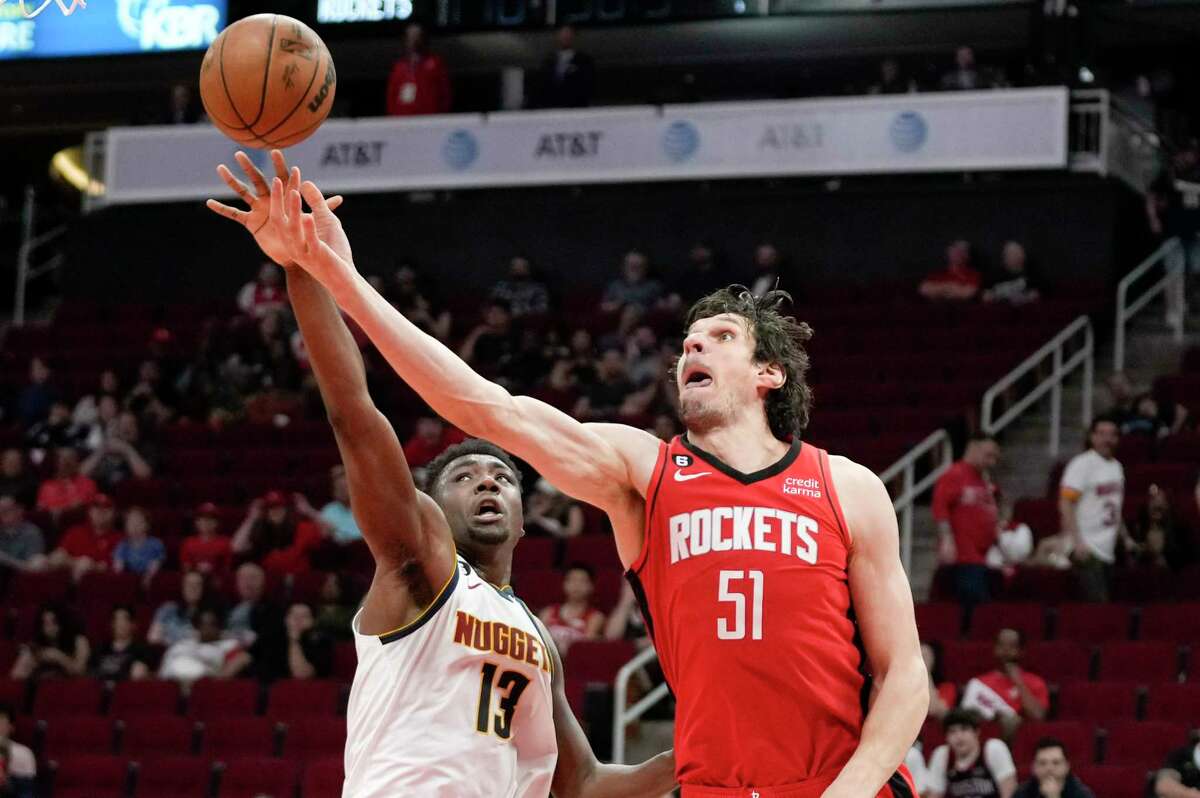 Houston Rockets center Boban Marjanovic (51) shoots as Denver Nuggets center Thomas Bryant defends during the second half of an NBA basketball game, Tuesday, Feb. 28, 2023, in Houston. (AP Photo/Eric Christian Smith)