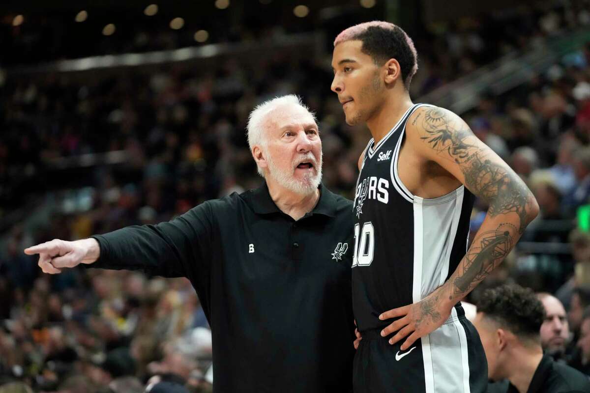 San Antonio Spurs head coach Gregg Popovich speaks with Jeremy Sochan (10) during the first half of an NBA basketball game against the Utah Jazz Tuesday, Feb. 28, 2023, in Salt Lake City.