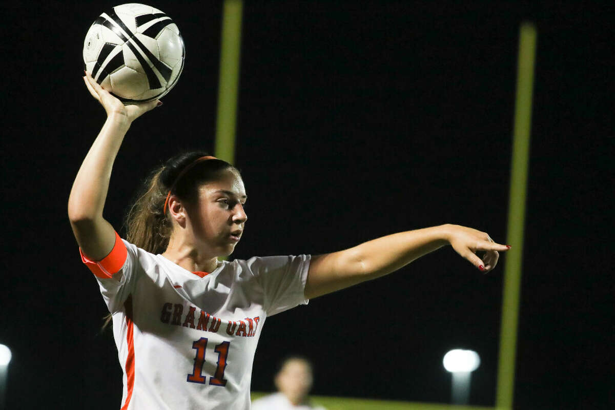Grand Oaks’ Lauren Moylan (11) motions as she prepares to throw the ball in bounds during a District 13-6 high school soccer match at The Woodlands High School, Tuesday, Feb. 28, 2023, in The Woodlands.