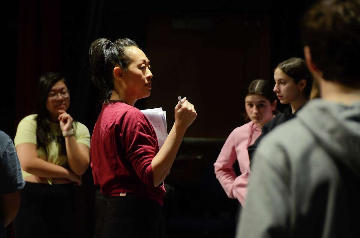 Tap choreographer Sally Hong works with students teaching them the intricate dance steps.