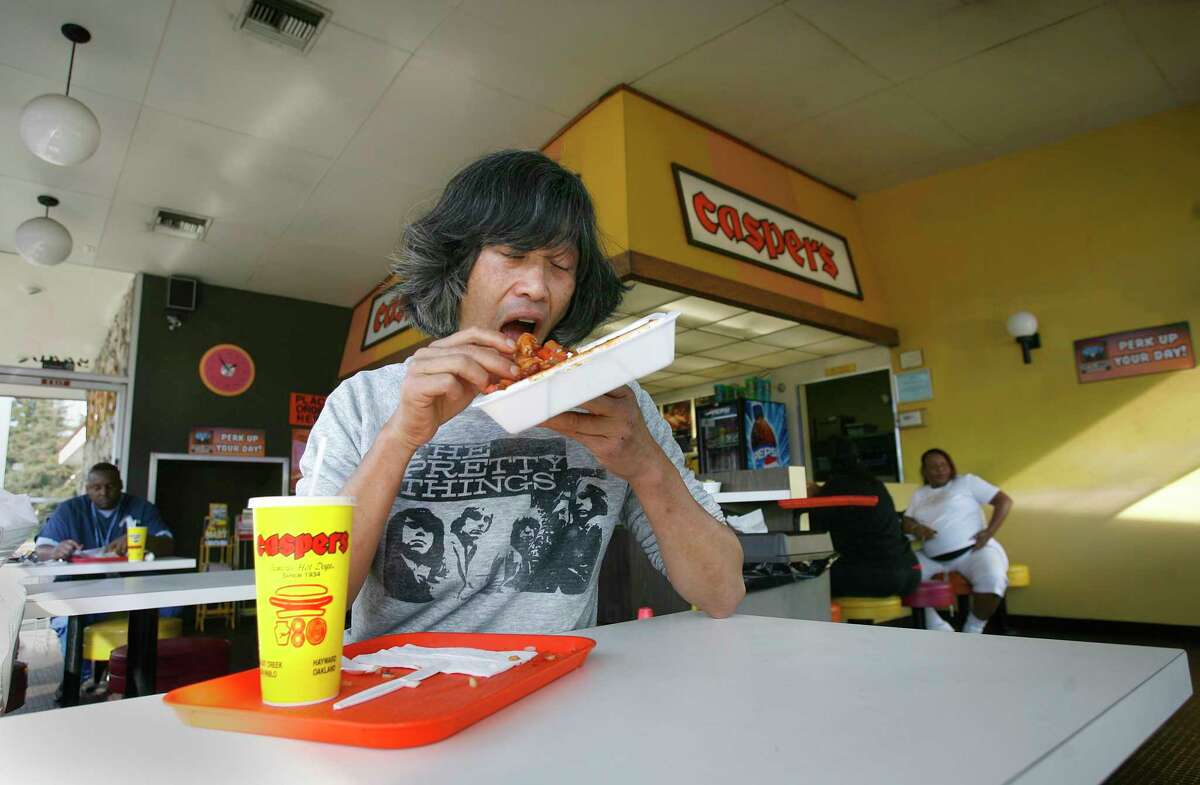 Russell Quan at Caspers Hot Dogs in Oakland in 2006. The chain's Walnut Creek location is closing in April.