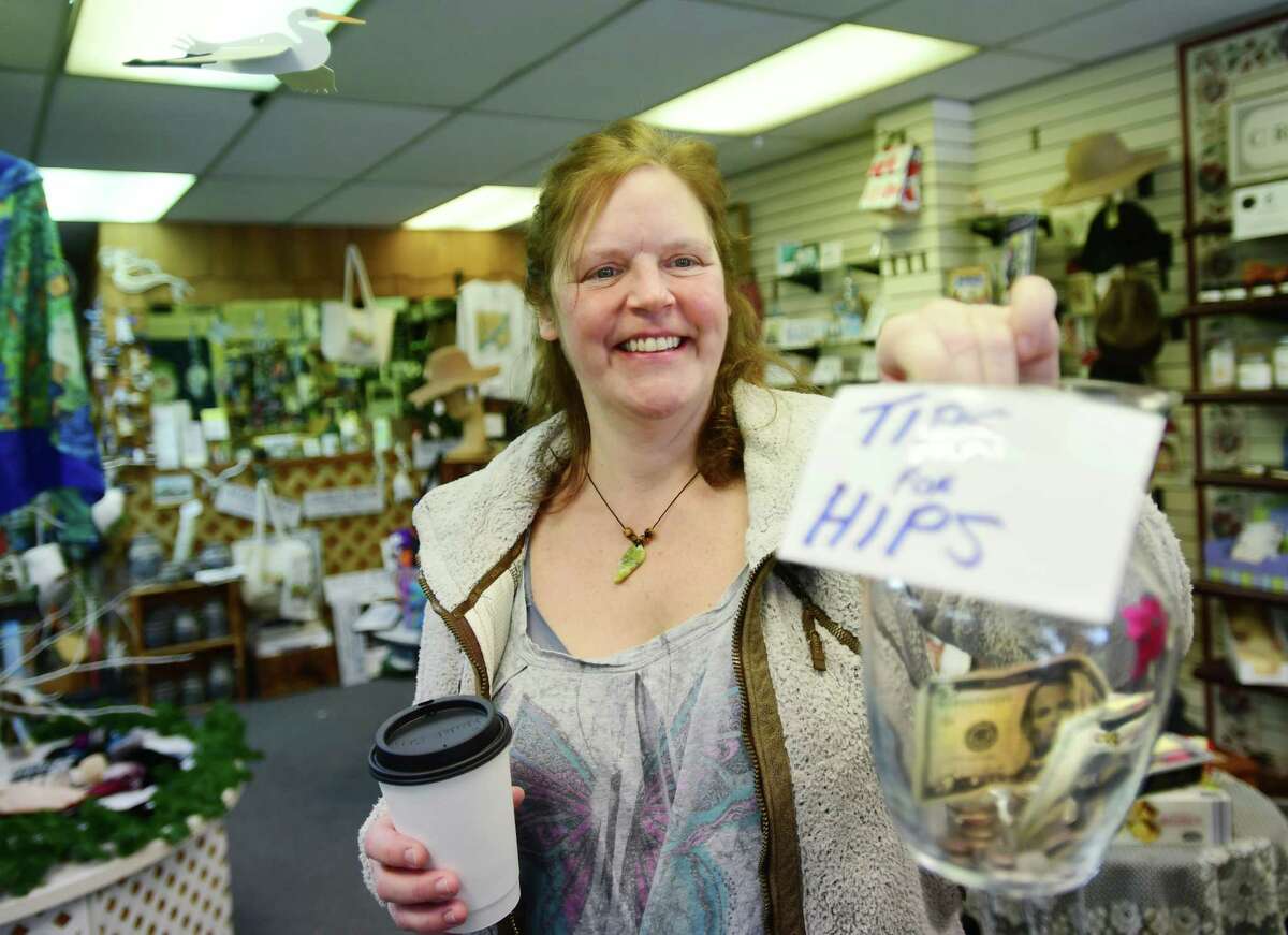 Carrie Reed is collecting tips as she runs The Canvas Patch, their mother Marti Reed's downtown retail business, while she recovers from a broken hip and hip replacement surgery, in Milford, Conn. on Wednesday, March 01, 2023.