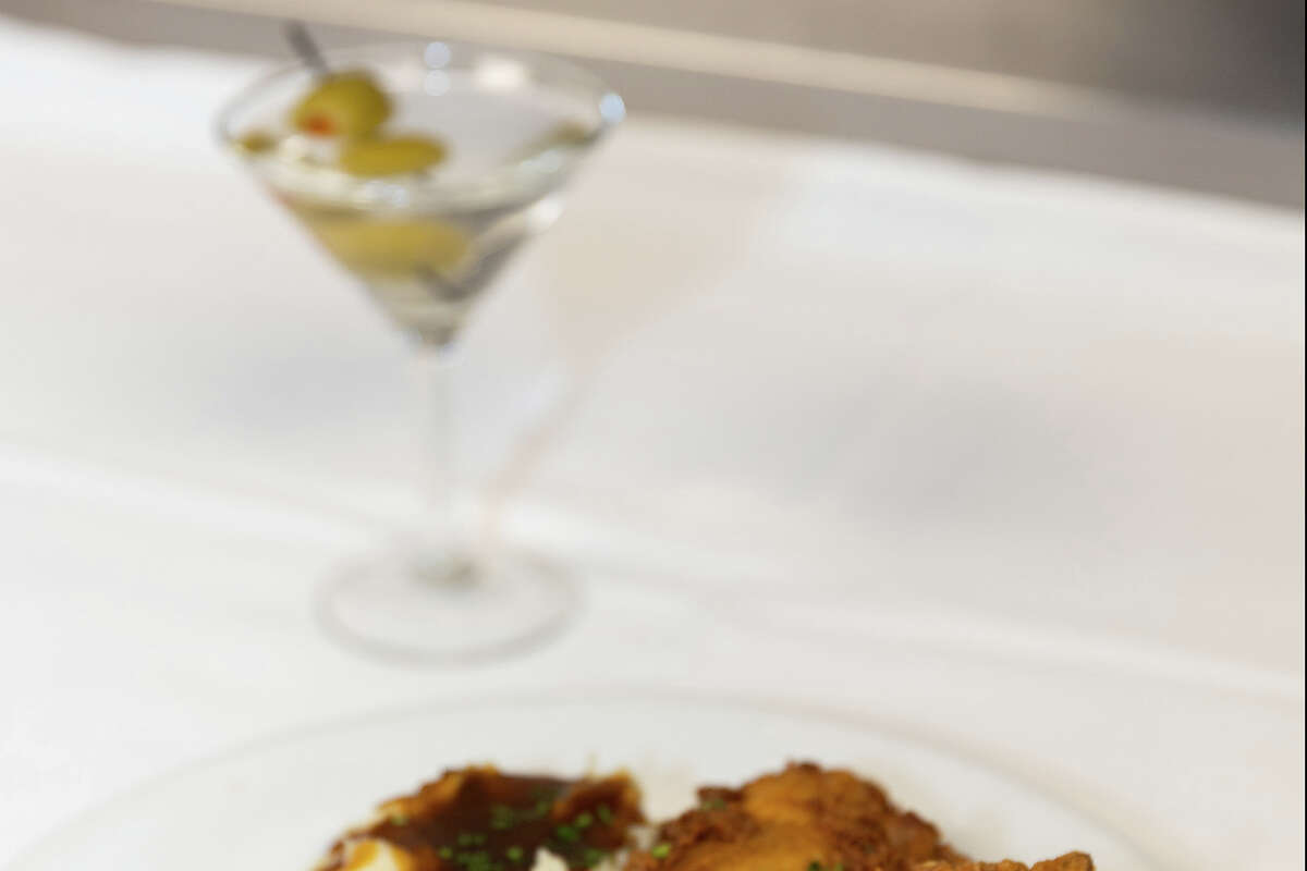 A plate of fried chicken, green beans, mashed potatoes and gravy, and a martini at the Gold Club in San Francisco on February 28, 2023. 