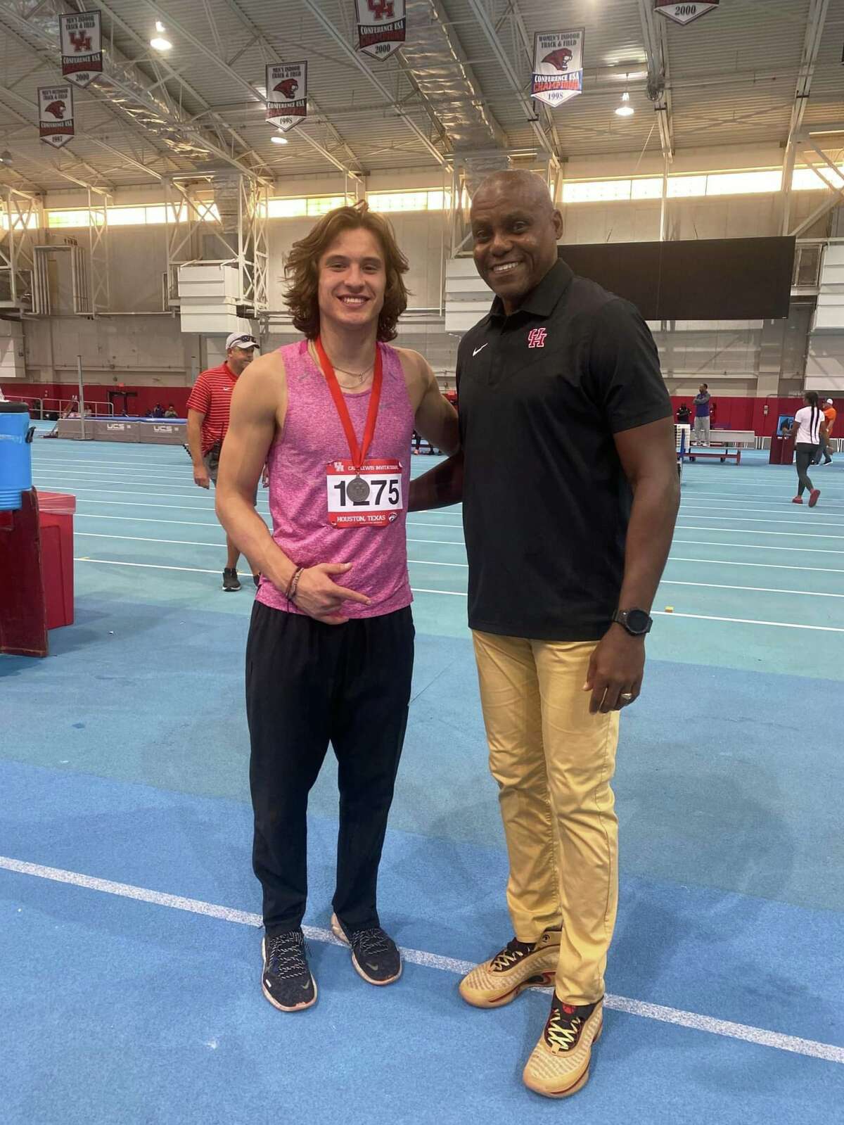 John Sanderson poses with Carl Lewis at the University of Houston.
