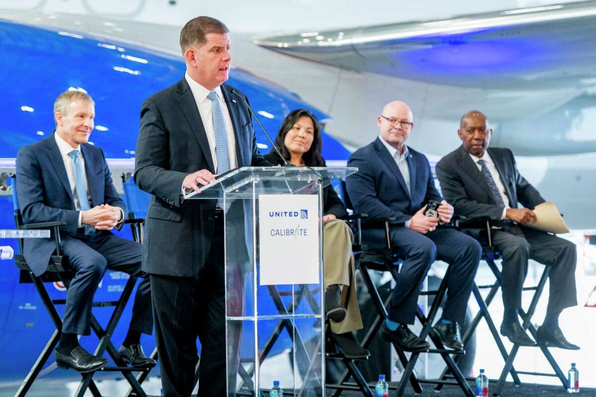 Dignitaries including Secretary of Labor Marty Walsh, Deputy Secretary Julie Su, Teamsters President Sean O'Brien, United Airlines CEO Scott Kirby and Houston Mayor Sylvester Turner meet with workers at Houston's George Bush Intercontinental Airport on Tuesday for the launch of Calibrate, a training program for aircraft maintenance technicians.