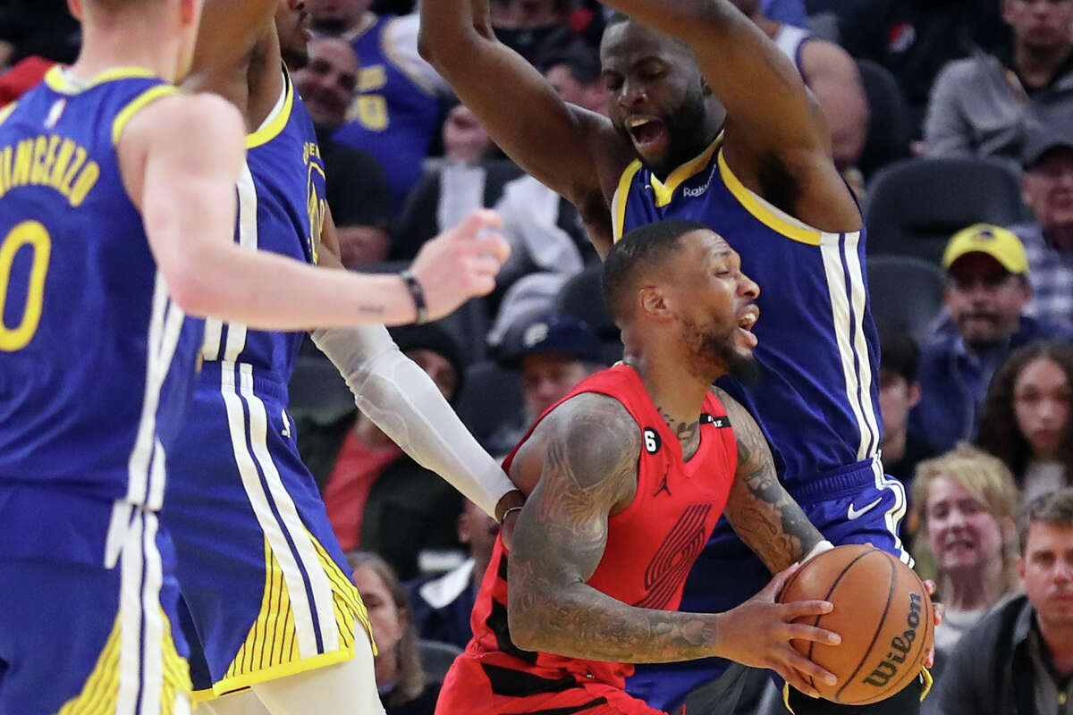 Golden State Warriors’ Draymond Green fouls Portland Trail Blazers’ Damina Lillard in 2nd quarter during NBA game at Chase Center in San Francisco, Calif., on Tuesday, February 28, 2023.
