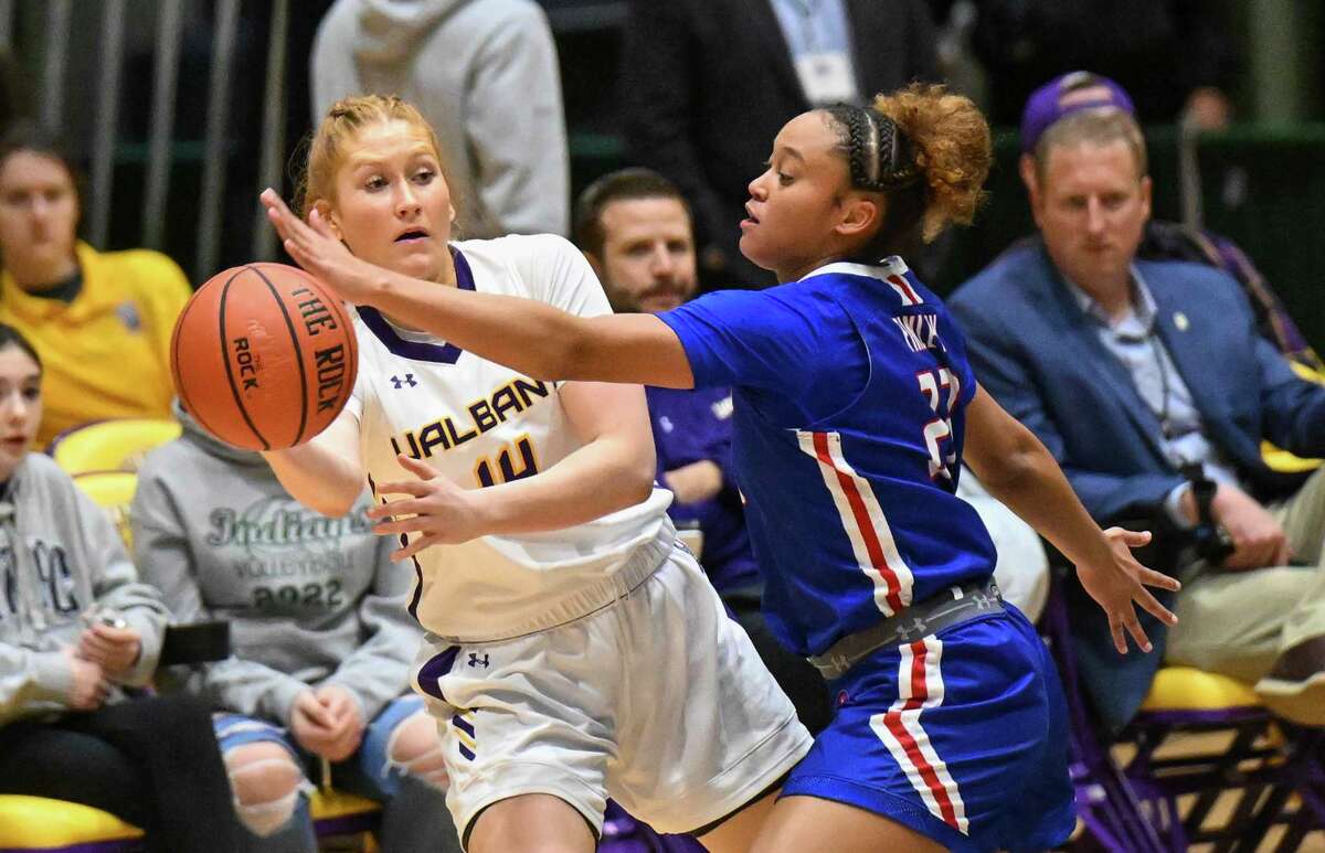 UAlbany guard Grace Heeps (14) moves the ball against UMass Lowell guard Ivory Finley (23) during the first half of their America East quarterfinal.