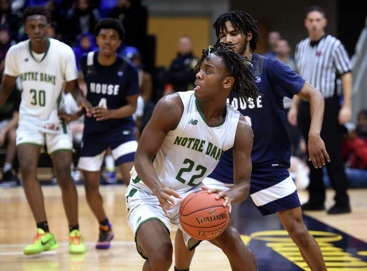 Tajae Jones, center, of Notre Dame of West Haven looks for an outlet against Hillhouse in the SCC Boys Basketball Championship at Quinnipiac University's M&T Bank Arena in Hamden on March 1, 2023.