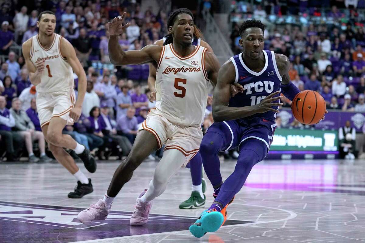 TCU guard Damion Baugh (10) is defended by Texas guard Marcus Carr (5) late in the second half of an NCAA college basketball game Wednesday, March 1, 2023, in Fort Worth, Texas. (AP Photo/Tony Gutierrez)