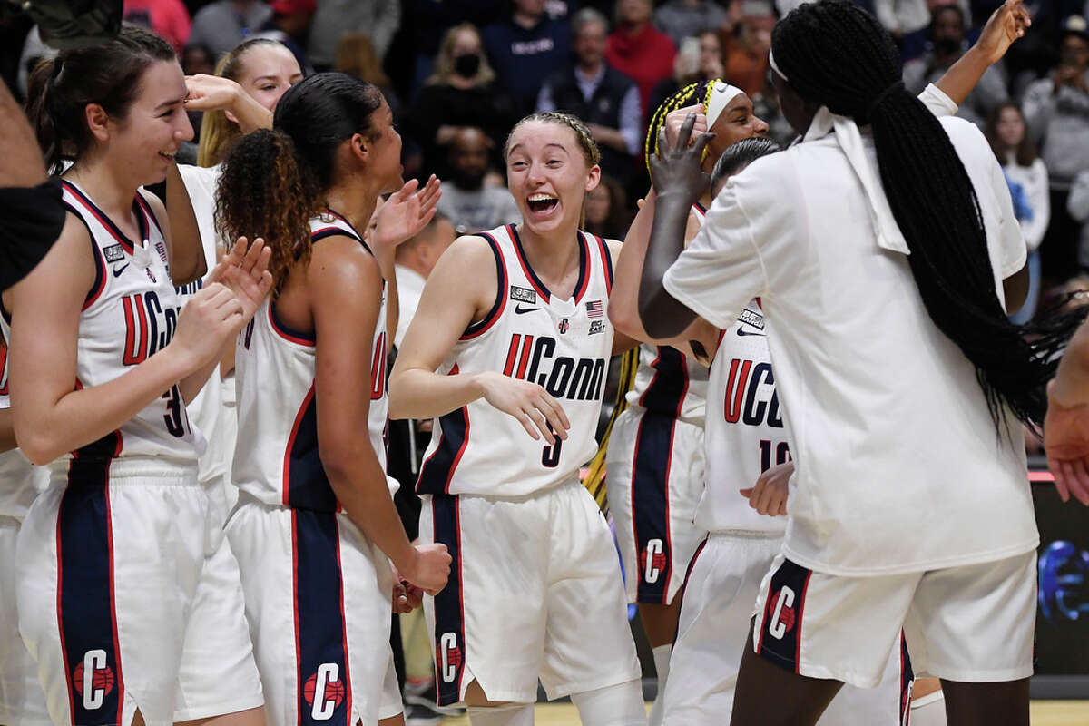 Connecticut's Paige Bueckers (5) and teammates celebrate their win against Villanova in an NCAA college basketball game in the Big East tournament final at Mohegan Sun Arena, Monday, March 7, 2022, in Uncasville, Conn. (AP Photo/Jessica Hill)