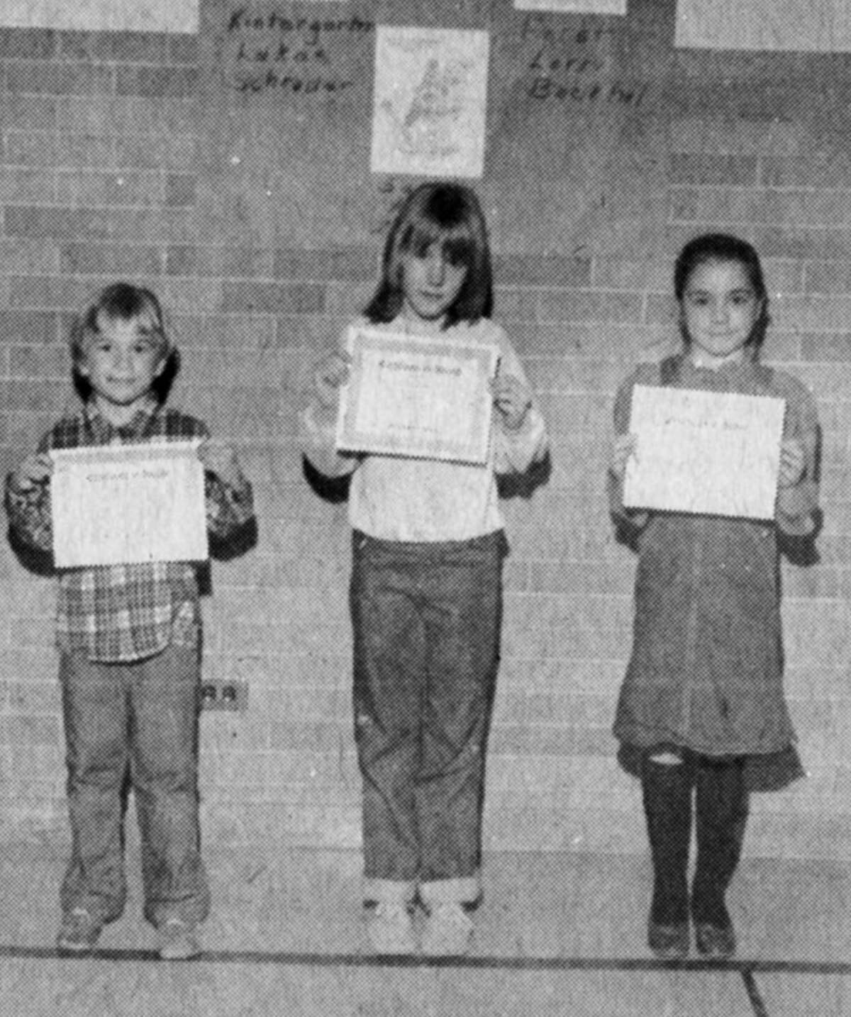 Winners of the poster contest for National Dental Health Month show off their certificates beneath their prize-winning creations displayed at Central Elementary. (From left) Lukas Schrader, kindergarten winner; Amy Zuchowski, second grade winner; Lorrie Bockhol, first grade winner. The photo was published in the News Advocate on March 3, 1983.